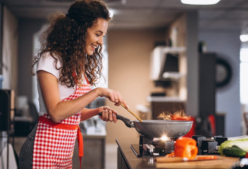 woman-chef-cooking-vegetables-in-pan